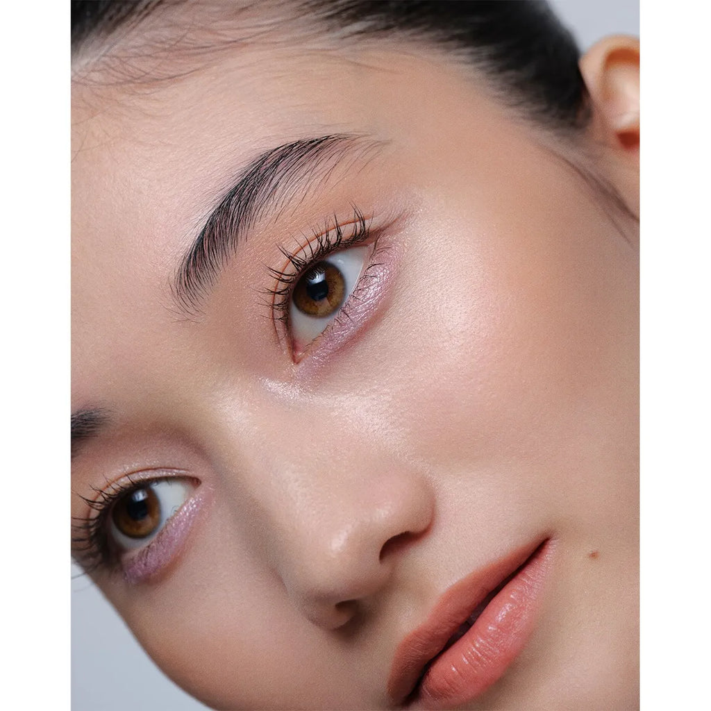 Close-up of a model wearing Addiction The Creamy Stick Eyeshadow in soft pink, showcasing a luminous and natural eye makeup look.