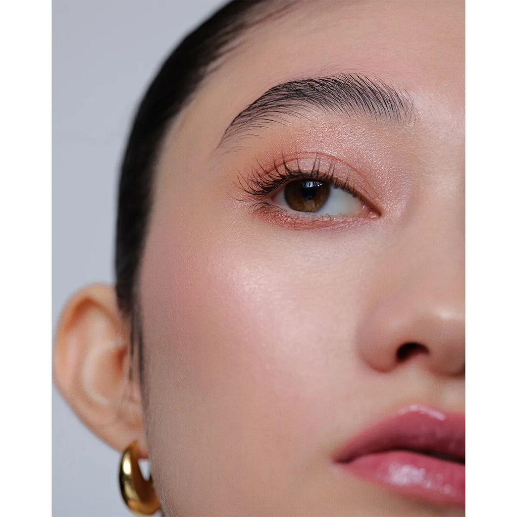 Close-up of a model wearing Addiction The Creamy Stick Eyeshadow in taupe, emphasizing a refined and polished eye makeup look.