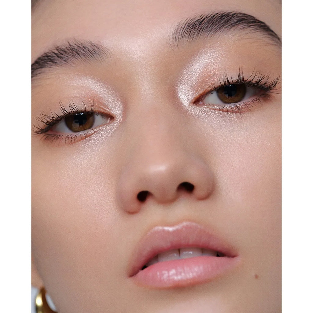 Close-up of a model wearing Addiction The Creamy Stick Eyeshadow in champagne, showcasing a glowing and elegant eye makeup effect.