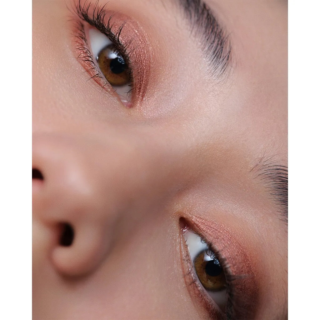 Close-up of a model wearing Addiction The Creamy Stick Eyeshadow in bronze, highlighting a bold and sultry eye makeup style.