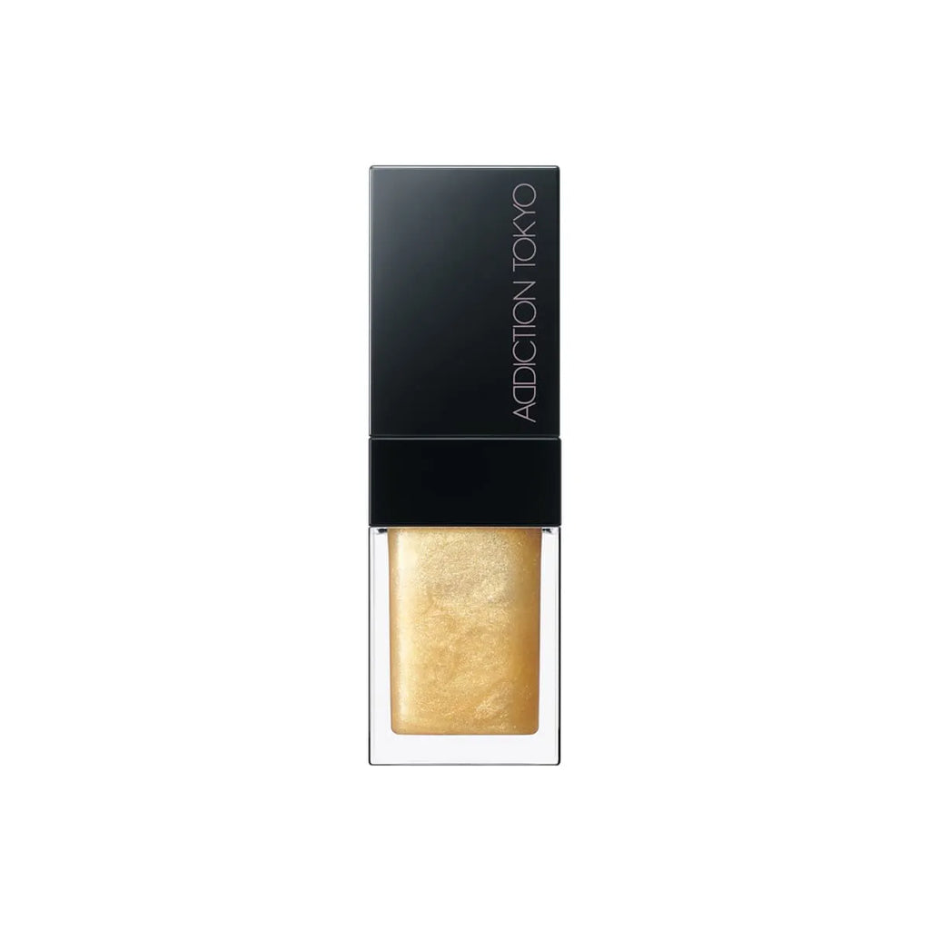 Addiction Tokyo Lip Oil Plumper 6.5ml in shimmering gold shade with a black cap, providing a radiant and glossy lip finish.