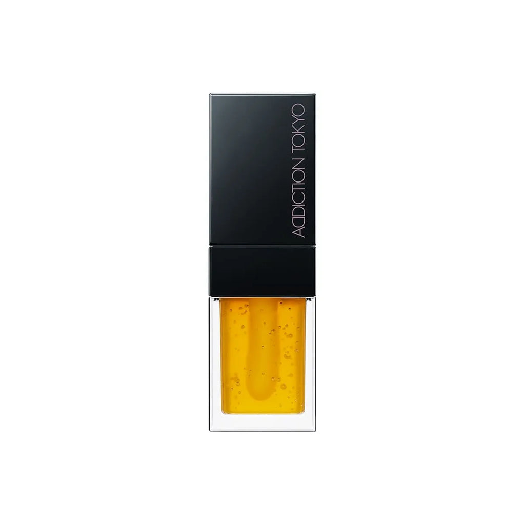 Addiction Tokyo Lip Oil Plumper 6.5ml in vibrant orange shade with a black cap, enriched with hydrating and plumping benefits.