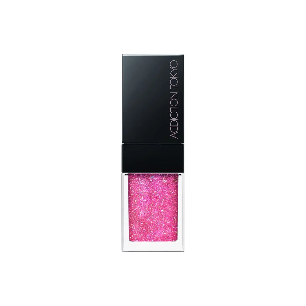 Addiction Tokyo Lip Oil Plumper 6.5ml in glittery pink shade with a black cap, offering a sparkling and moisturizing lip finish.