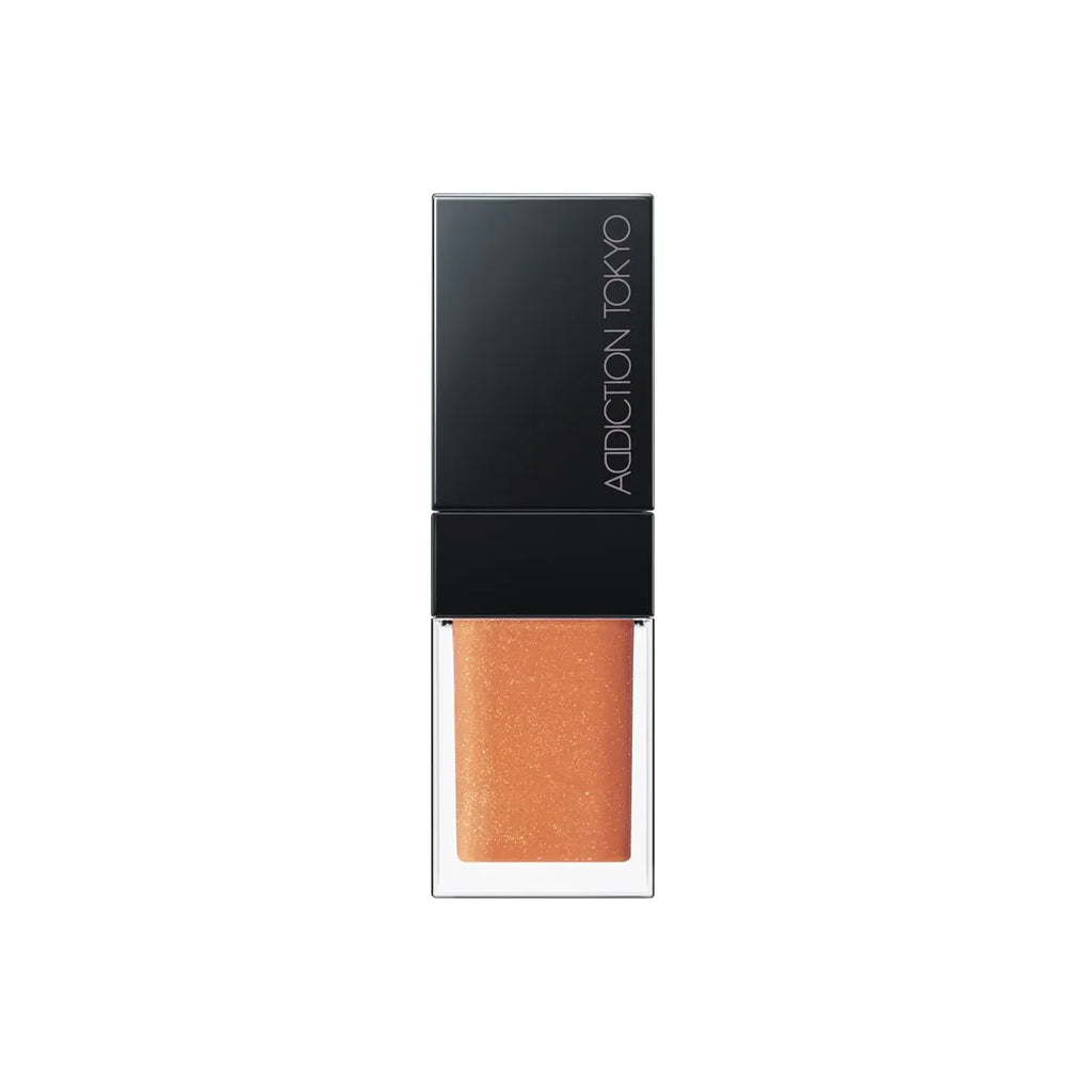 Addiction Tokyo Lip Oil Plumper 6.5ml in shimmering peach shade with a black cap, perfect for a glossy and hydrating lip effect.