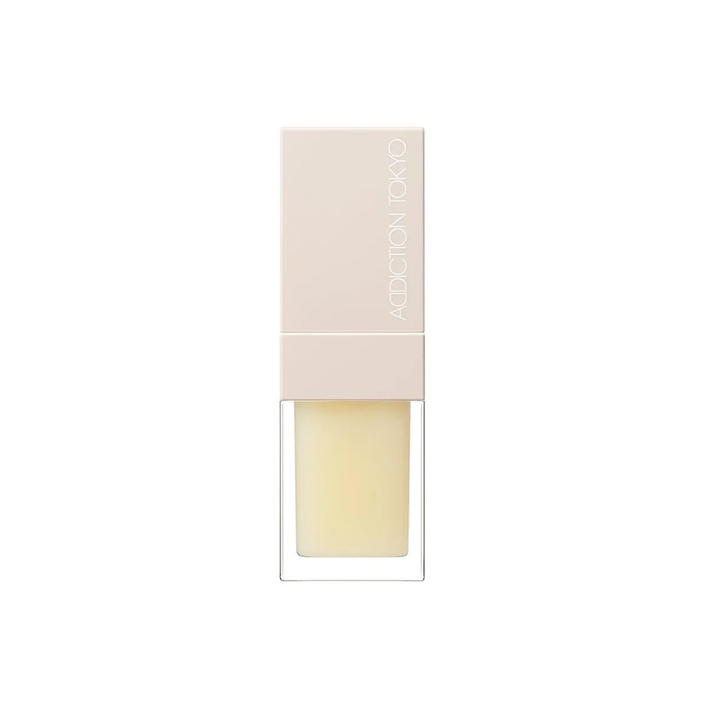 Addiction Tokyo Lip Oil Plumper 6.5ml in pale yellow shade with a beige cap, designed for moisturizing and plumping lips.