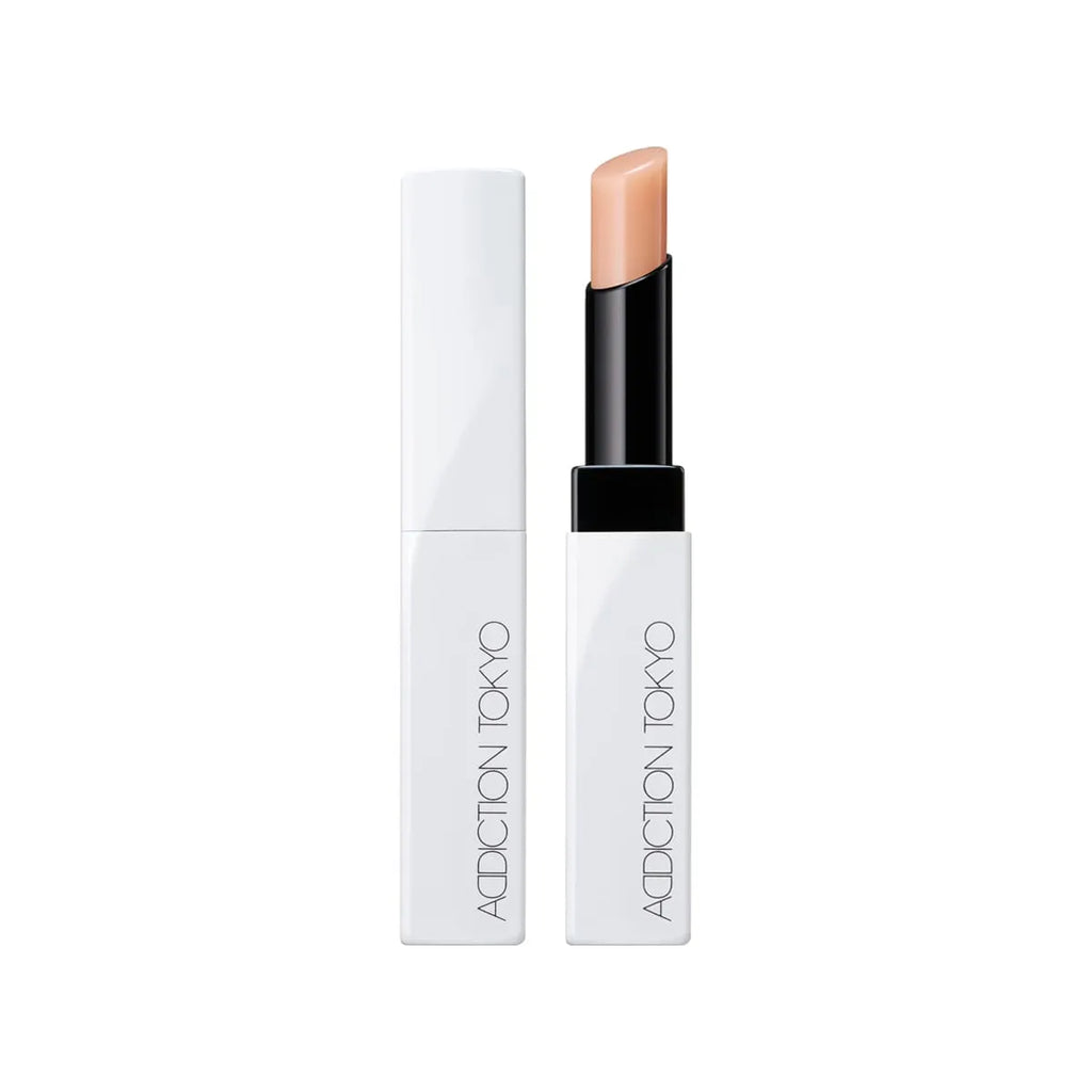 Addiction Tokyo Lip Balm Glow Tint in a soft nude shade, featuring a sleek white tube design with black accents for natural glossy lips.