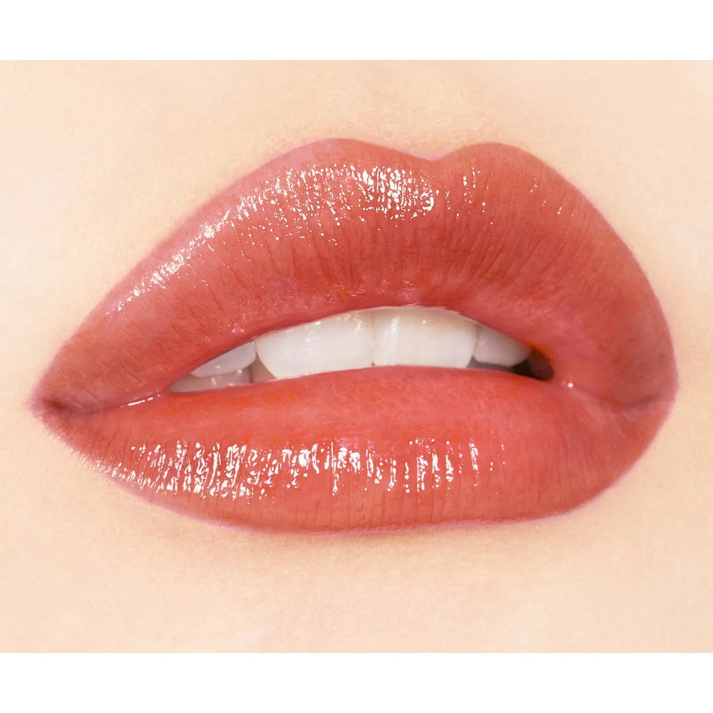 Close-up of lips wearing Addiction Tokyo Lip Balm Glow Tint in a pink shade, highlighting a vibrant, glossy finish.