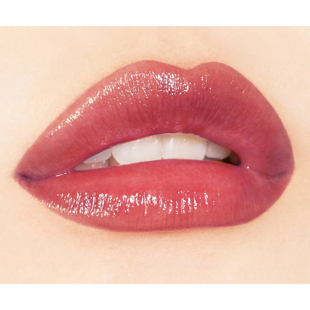 Close-up of lips wearing Addiction Tokyo Lip Balm Glow Tint in a mauve shade, emphasizing a rich, glossy texture.