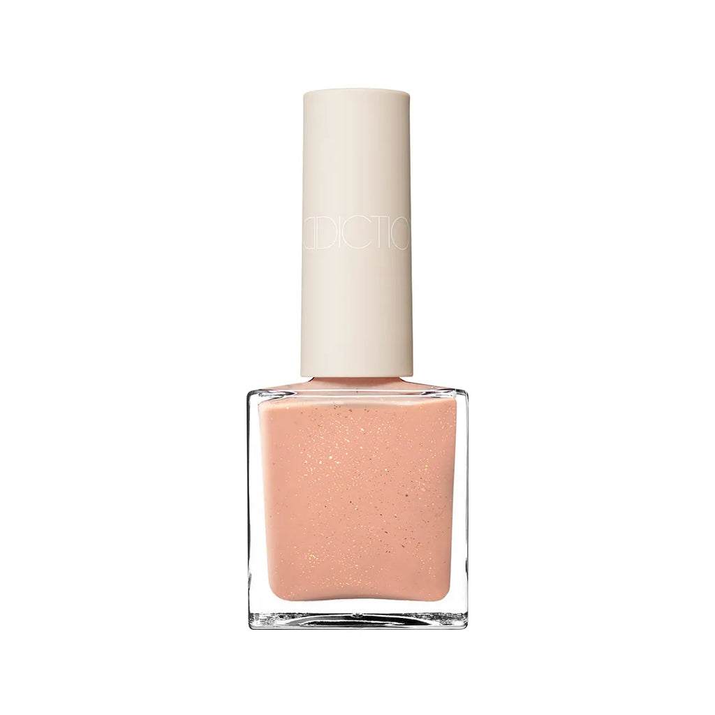 Addiction Tokyo Nail Polish in a peachy nude shade with subtle shimmer. Glossy, quick-drying, and 9-free for healthier nails.