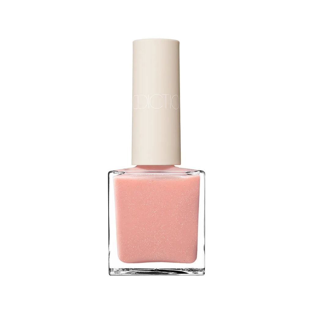 Addiction Tokyo Nail Polish in a light pink shade with fine shimmer. Glossy, quick-drying, and 9-free for elegant fingertips.