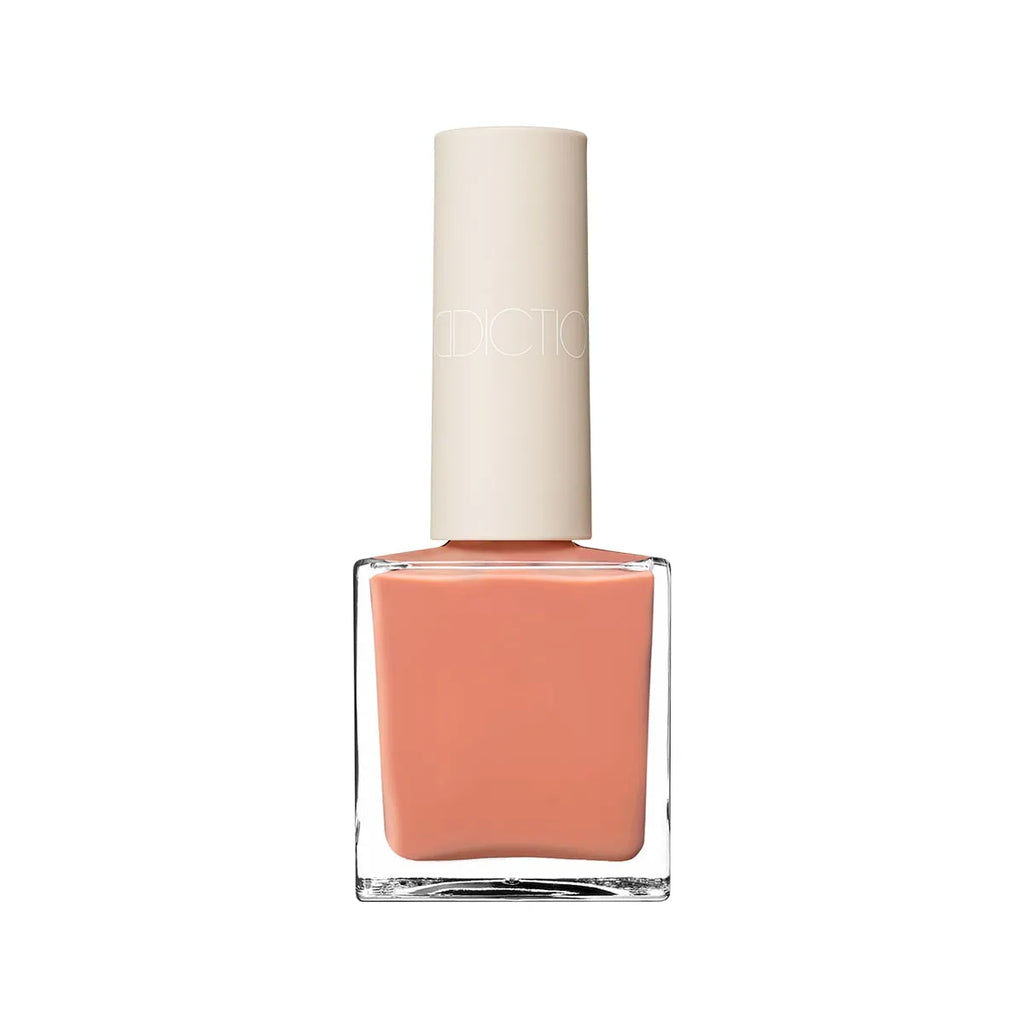 Addiction Tokyo Nail Polish in a vibrant coral shade with a glossy finish. Quick-drying, long-lasting, and 9-free for nail care.