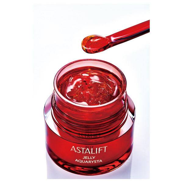 Astalift Jelly Auqarysta serum in an open jar with an applicator, highlighting its jelly texture for effective skin hydration.