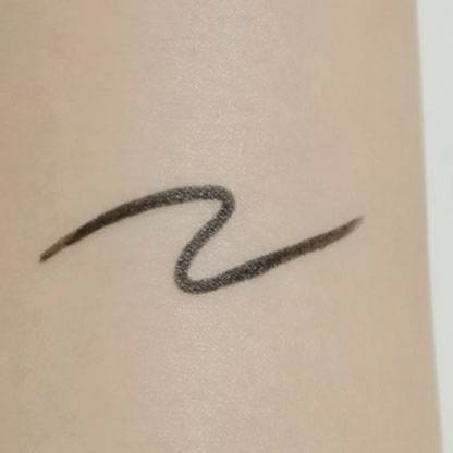Swatch of Canmake Creamy Touch Liner on skin, showing its creamy texture and rich pigmentation in a single stroke.