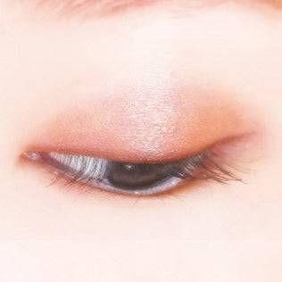 Close-up of an eyelid wearing Canmake Silky Flare Eyes matte type eyeshadow in warm bronze and gold tones with a soft shimmer effect.