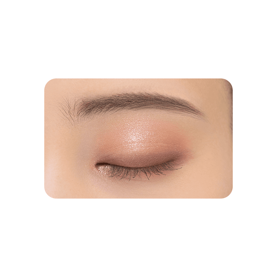 Close-up of an eyelid wearing Cezanne Bitter Tone Eyeshadow in pinkish-brown tones, highlighting a subtle shimmer and smooth blend.