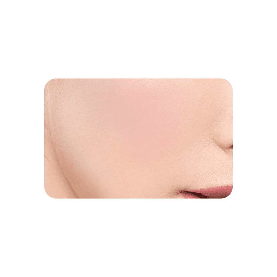 Close-up of a coral-toned Cezanne Cheek Blush applied on skin, delivering a radiant and natural glow.