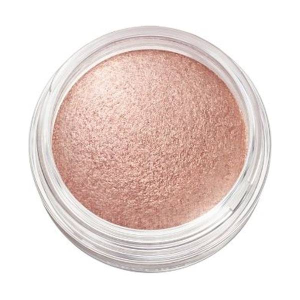 Close-up of Cosme Decorté Eye Glow Gem Skin Shadow in a peachy pink shade, emphasizing its smooth and vibrant texture.