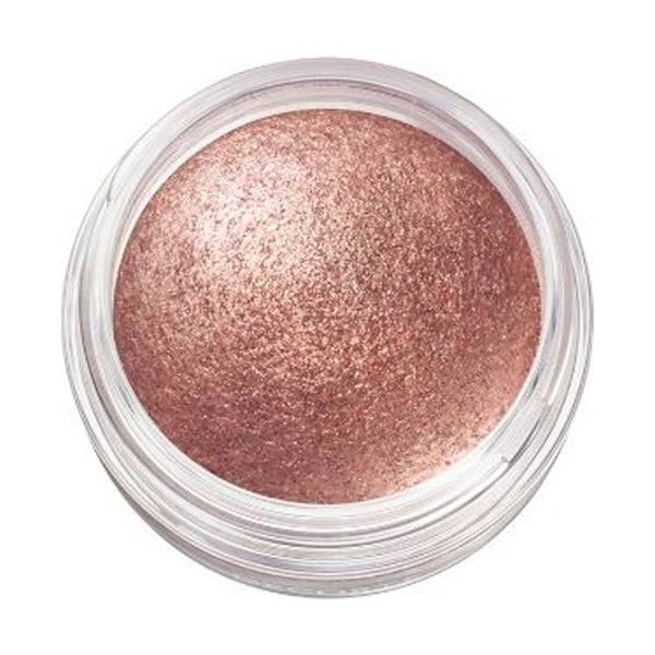 Close-up of Cosme Decorté Eye Glow Gem Skin Shadow in a coppery pink shade, showcasing its luminous and smooth texture.