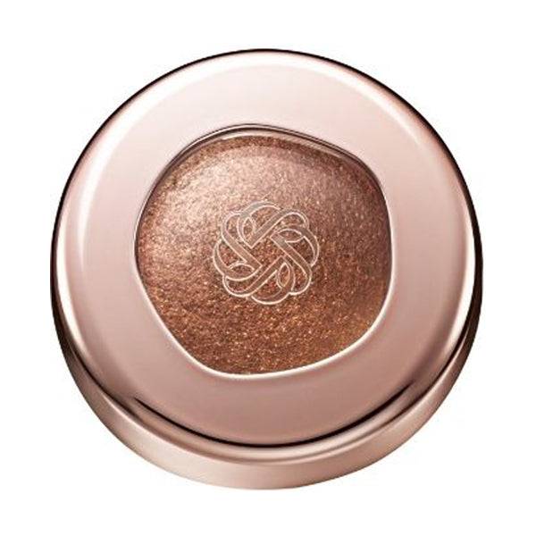 Cosme Decorté Eye Glow Gem Skin Shadow in a bronze brown shade with a metallic sheen, presented in a rose gold compact.