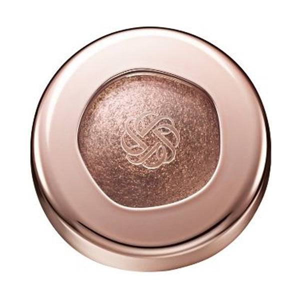 Cosme Decorté Eye Glow Gem Skin Shadow in a taupe brown shade with a radiant finish, encased in a rose gold compact.