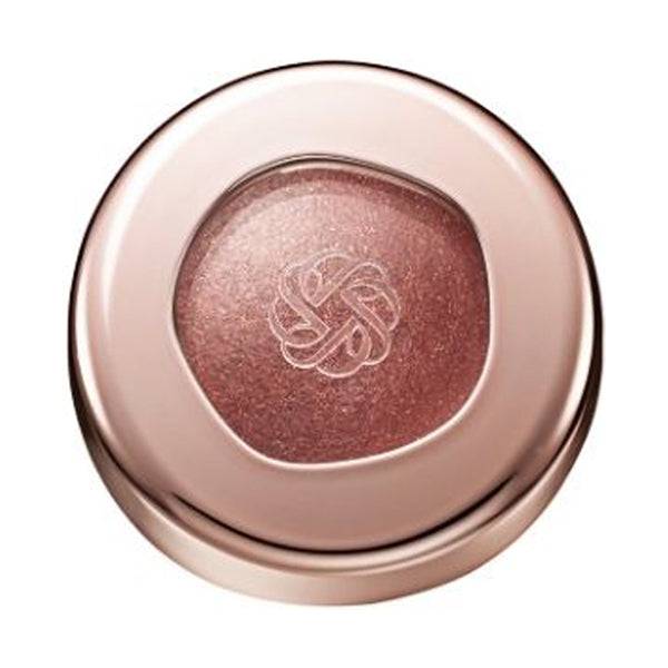 Cosme Decorté Eye Glow Gem Skin Shadow in a deep plum shade with a radiant finish, presented in a rose gold compact.
