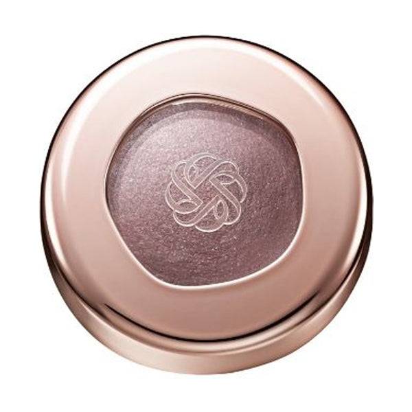 Cosme Decorté Eye Glow Gem Skin Shadow in a sleek rose gold container with a clear window showcasing the shimmering mauve eye shadow.