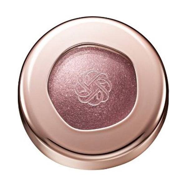 Cosme Decorté Eye Glow Gem Skin Shadow in a shimmering pink shade, housed in a sleek rose-gold compact with a transparent lid showcasing the product.
