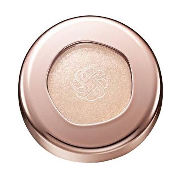 Cosme Decorté Eye Glow Gem Skin Shadow in a golden champagne shade with a shimmering finish, encased in a rose gold compact.