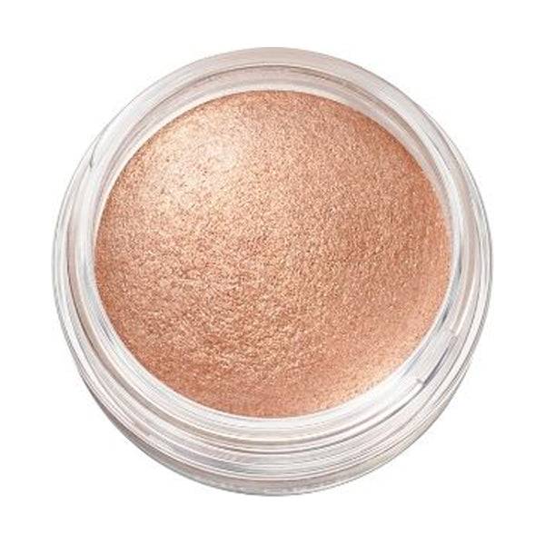 Close-up of Cosme Decorté Eye Glow Gem Skin Shadow in a warm bronze shade, emphasizing its metallic and smooth texture.