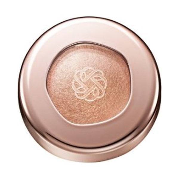 Cosme Decorté Eye Glow Gem Skin Shadow in a warm bronze shade with a metallic sheen, presented in a rose gold compact.