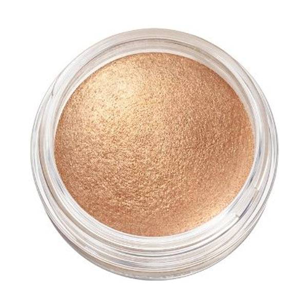 Close-up of Cosme Decorté Eye Glow Gem Skin Shadow in a golden bronze shade, showcasing its luminous and smooth texture.