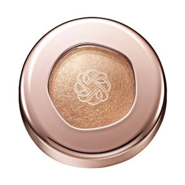 Cosme Decorté Eye Glow Gem Skin Shadow in a golden bronze shade with a radiant finish, encased in a rose gold compact.