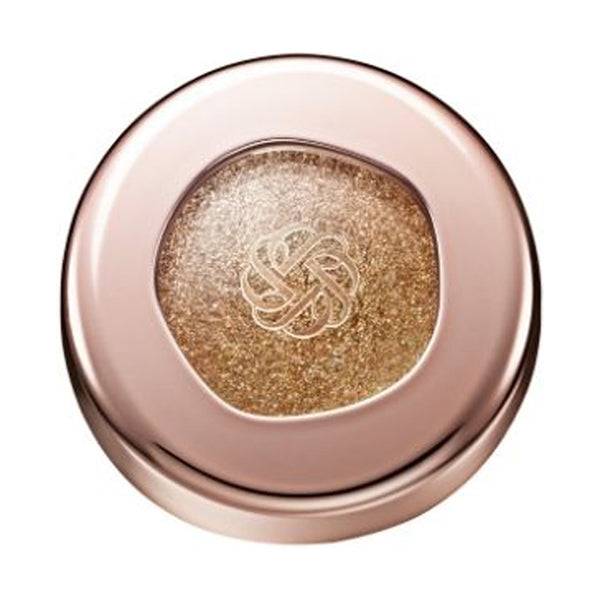 Cosme Decorté Eye Glow Gem Skin Shadow in a glittery gold shade with a sparkling finish, housed in a rose gold compact.