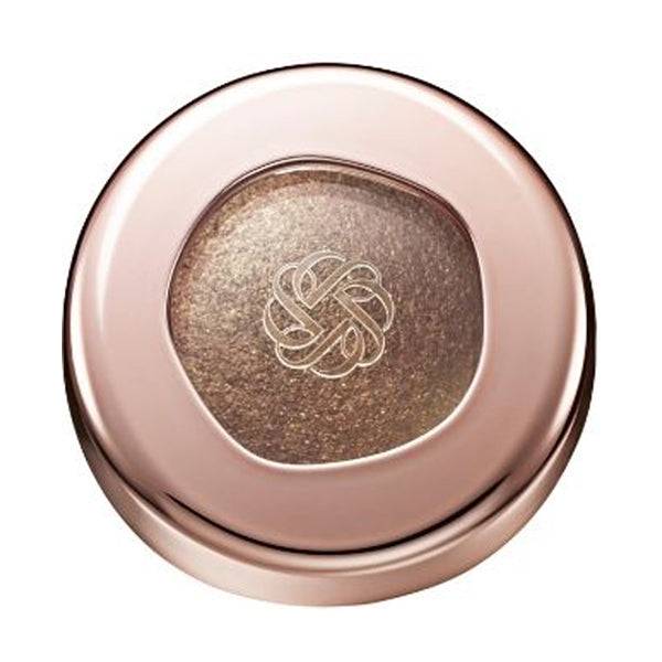 Cosme Decorté Eye Glow Gem Skin Shadow in a deep brown shade with a metallic finish, presented in a rose gold compact.