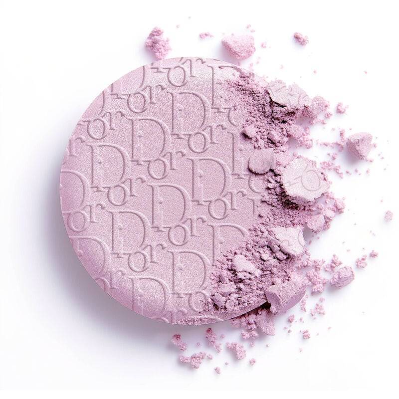 Close-up of Dior Skin Forever Couture Luminizer 2025 Edition in lavender shade, with embossed Dior logo and partially crushed powder texture.