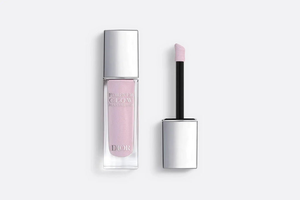 Dior Forever Glow Highlighter in pearly pink shade with applicator, featuring a sleek silver cap and luxurious liquid formula.