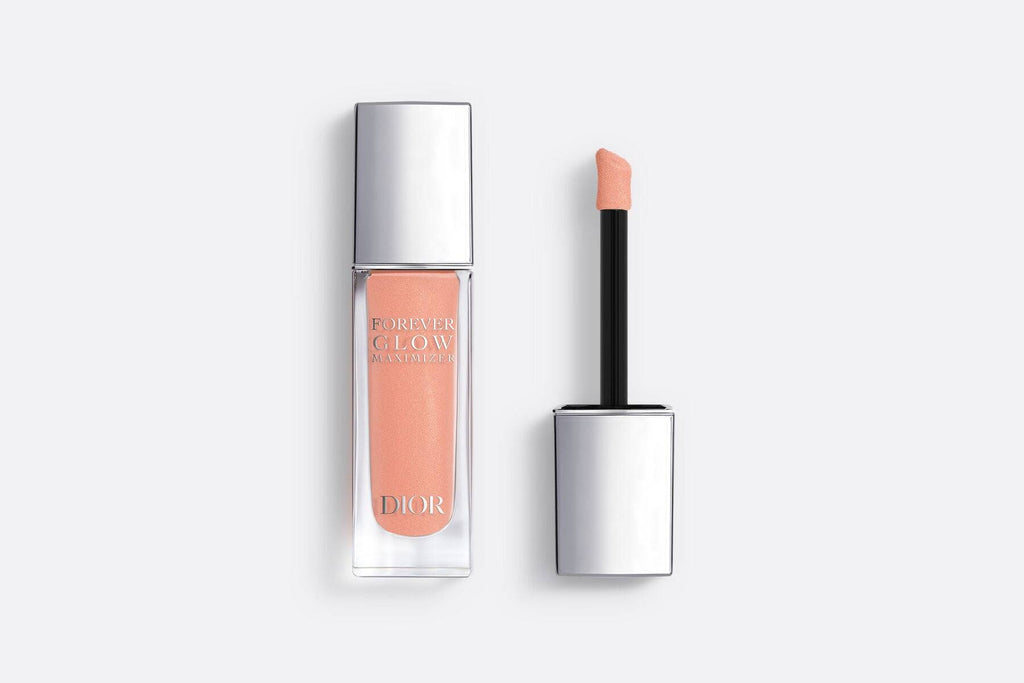 Dior Forever Glow Highlighter in peachy shade with applicator, elegantly packaged with a silver cap for a radiant glow.