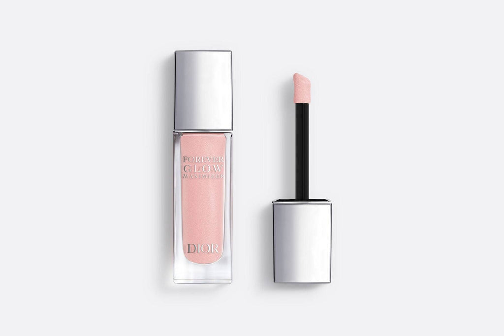 Dior Forever Glow Highlighter in rosy pink shade with applicator, featuring a luxurious silver cap and radiant liquid formula.