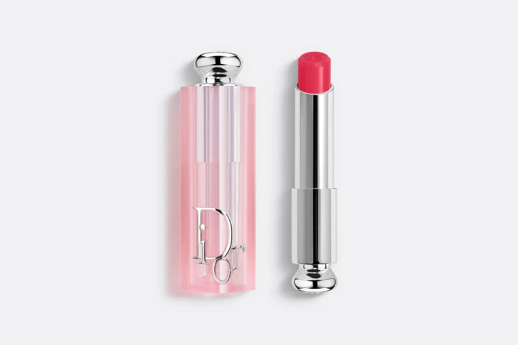 Dior Addict Lip Glow lipstick in a deep rose shade, providing hydration and a custom color effect. Encased in a pink translucent tube.