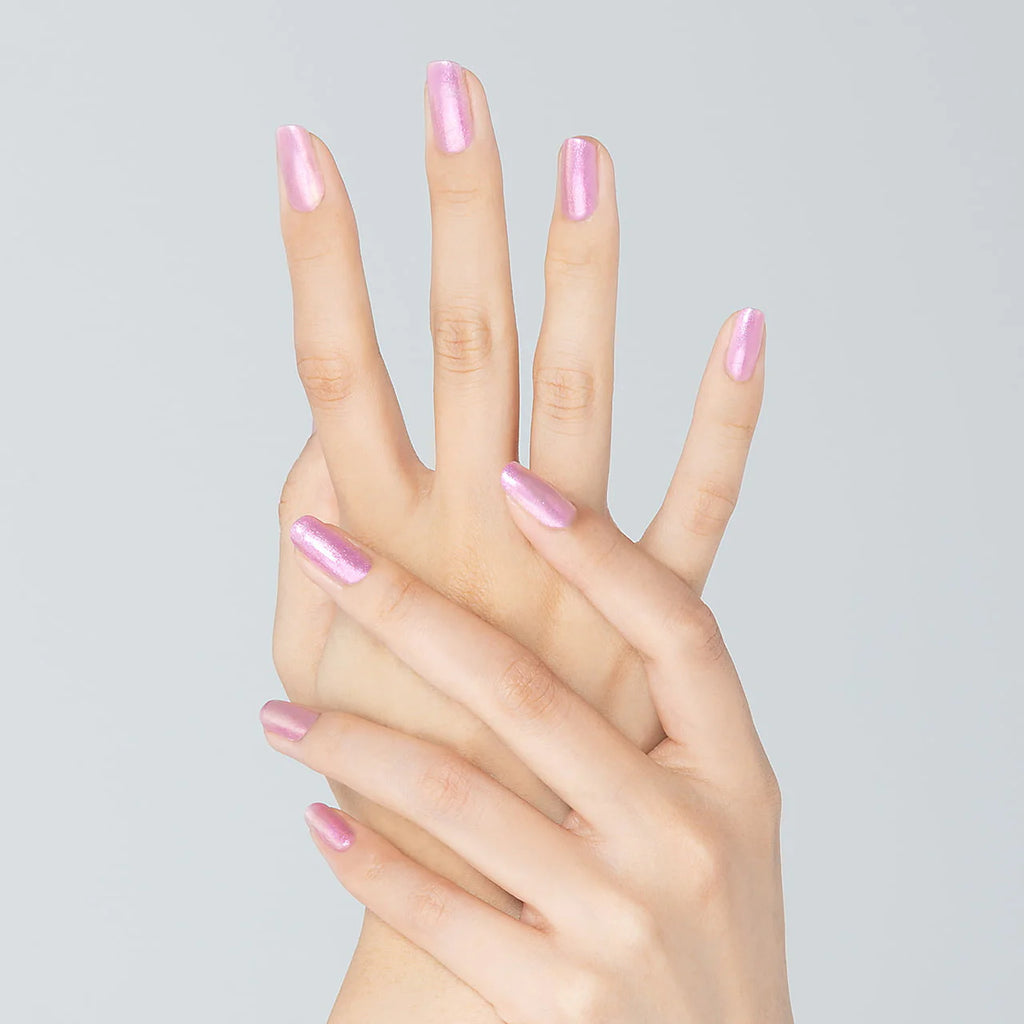 Hands with nails painted in shimmering pink Elégance Lacquer, showcasing a glossy finish for a feminine and stylish look.