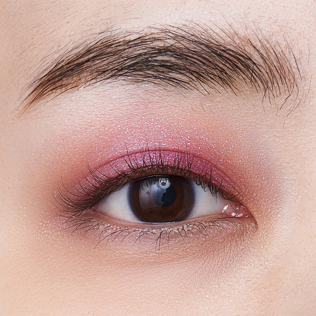 Close-up of an eyelid featuring Elégance Razzle Eye Color in purple, showcasing a vivid and glamorous eye makeup look.