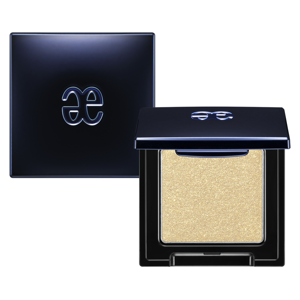 Elégance Razzle Eye Color in metallic gold shade, packaged in a sophisticated black compact. Ideal for luxurious and radiant eye makeup.