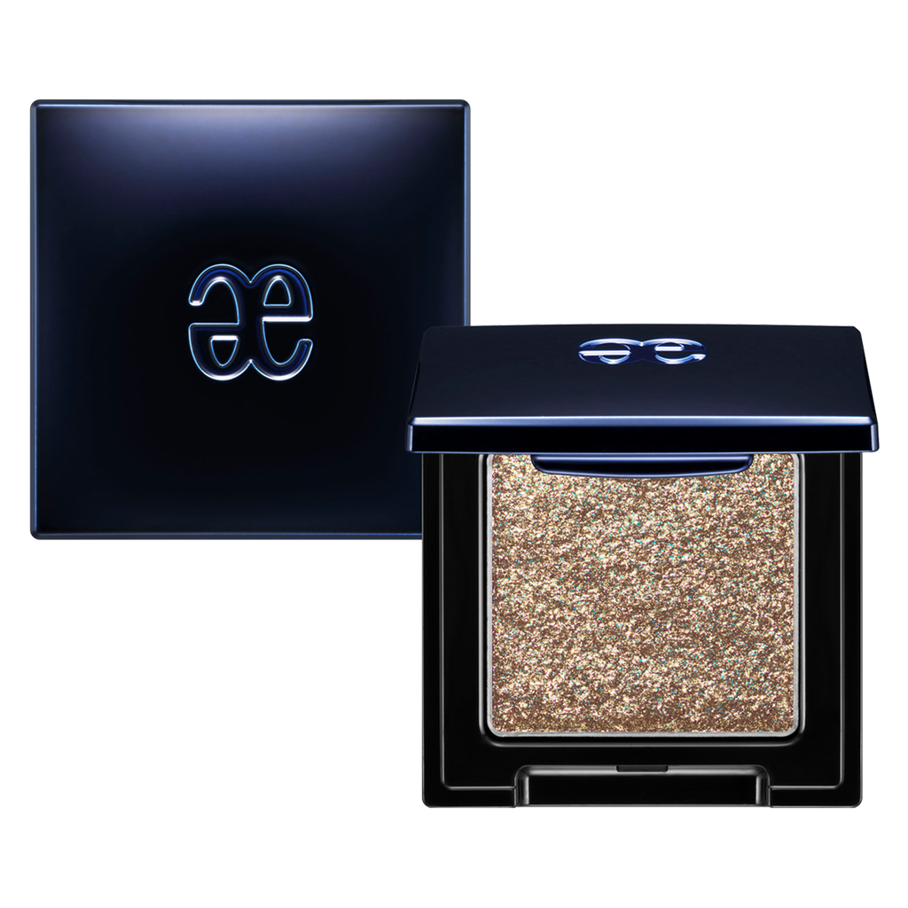 Elégance Razzle Eye Color in glittery bronze shade, housed in a modern black compact. Perfect for bold and shimmering eye makeup.