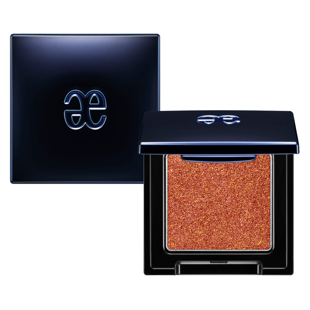 Elégance Razzle Eye Color in fiery orange shade, housed in a chic black compact. Perfect for bold and warm-toned eye makeup.