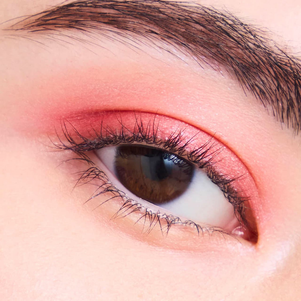 Close-up of an eyelid adorned with Elégance Razzle Eye Color in red, delivering a striking and glamorous eye makeup style.