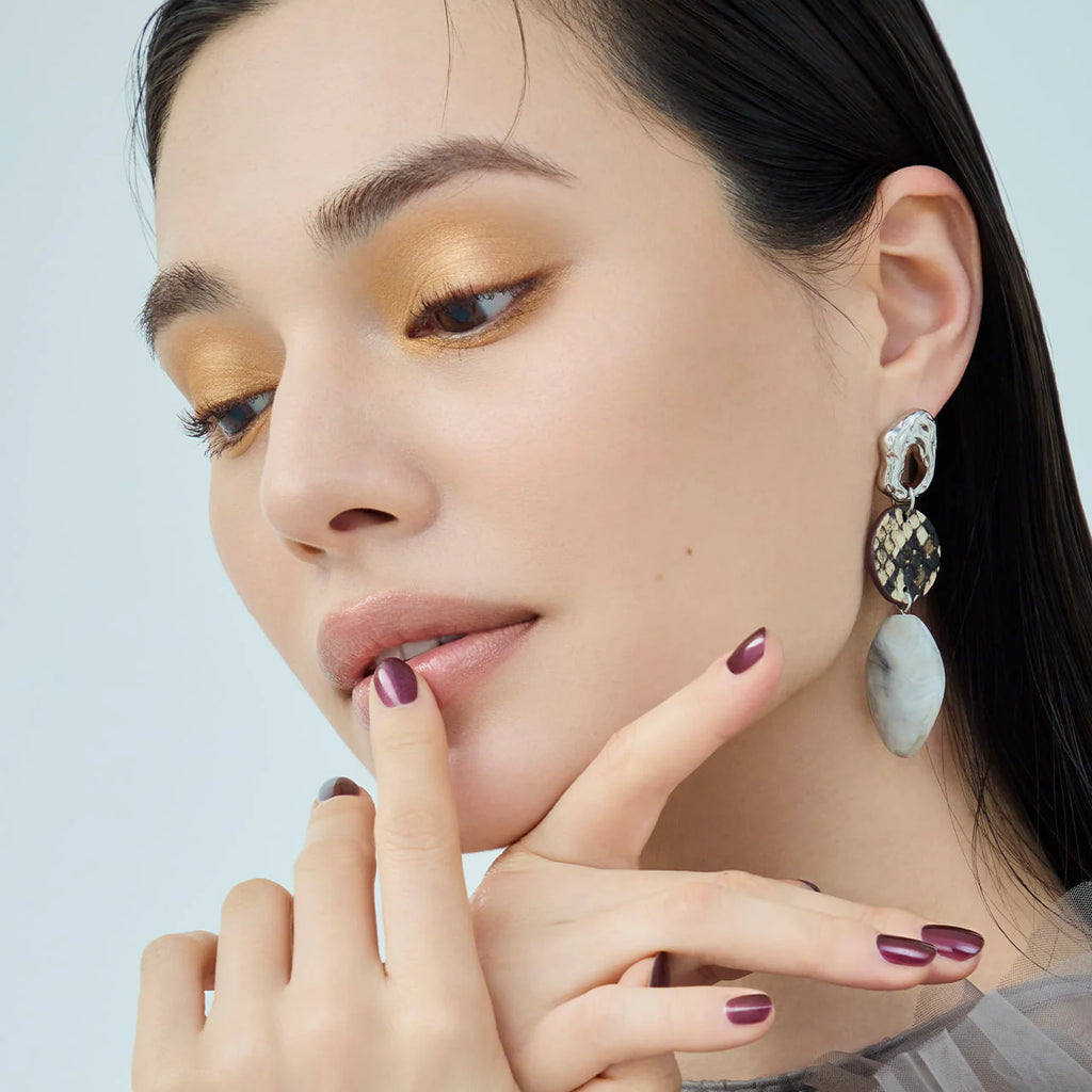 Close-up of a model wearing Elégance Razzle Eye Color in yellow, delivering a bold and glowing eye makeup style.