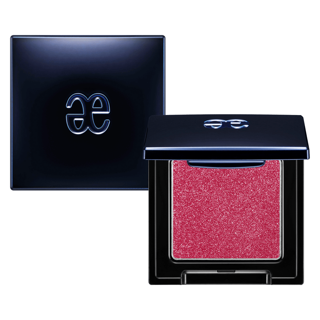 Elégance Razzle Eye Color in coral pink shade, encased in a stylish black compact. Ideal for vibrant and playful eye makeup.