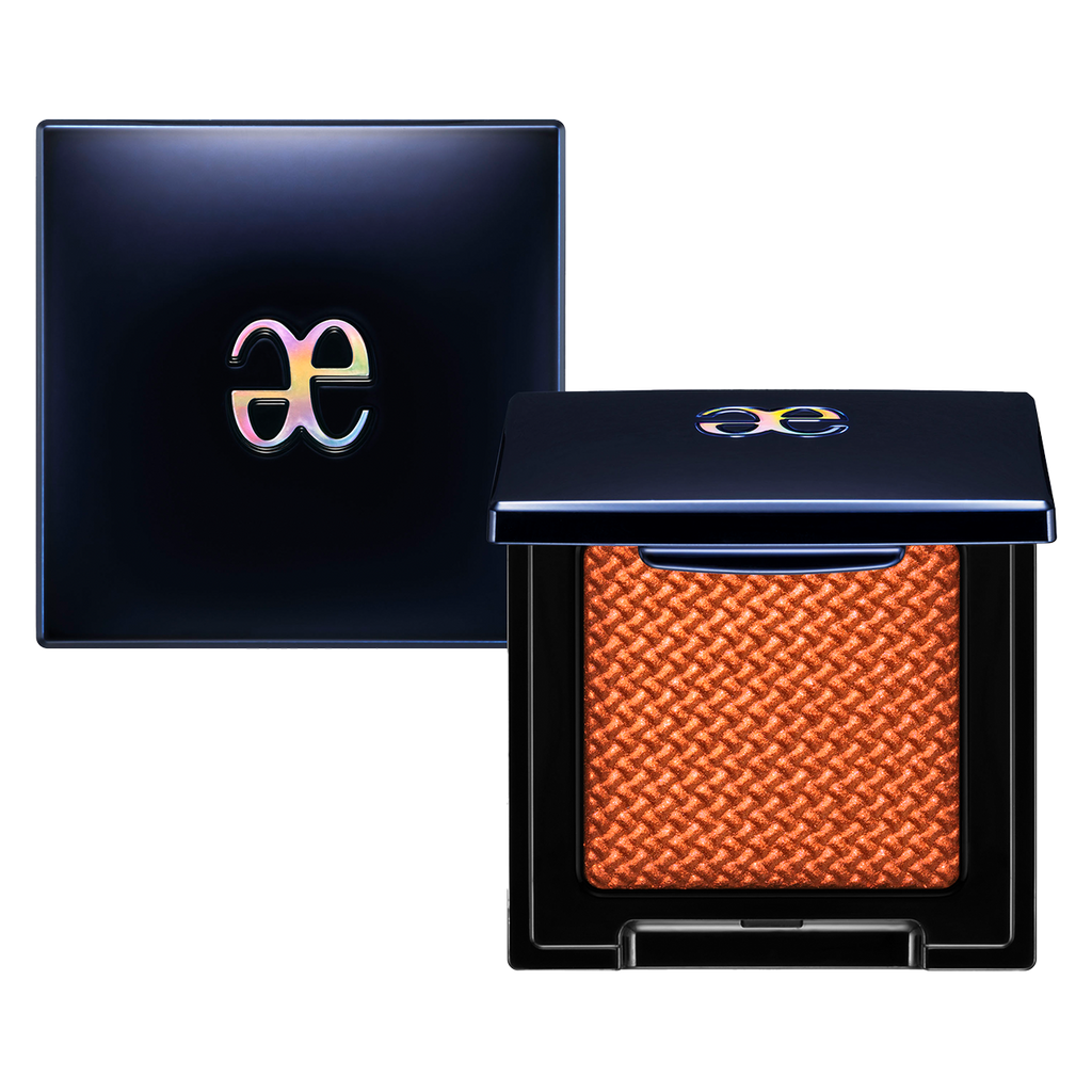 Elégance Razzle Star Eye Color in a bold orange shade with a textured finish, housed in a sleek black compact with a glossy logo.