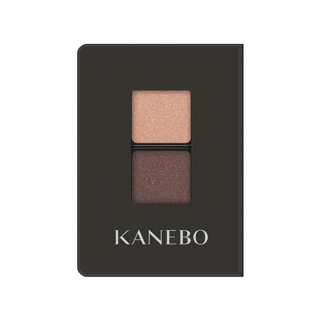 Kanebo Eye Color Duo with shimmering beige and brown shades in a sleek black compact, ideal for creating natural eye makeup looks.