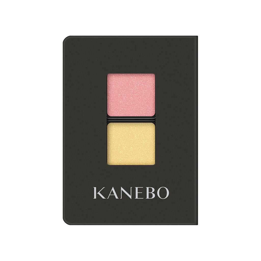 Kanebo Eye Color Duo with coral pink and yellow shades in a black compact, offering vibrant and playful eye makeup options.